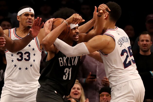 NEW YORK, NEW YORK - APRIL 20:  Jarrett Allen #31 of the Brooklyn Nets is surrounded by Tobias Harris #33 and Ben Simmons #25 of the Philadelphia 76ers in the final seconds of the game at Barclays Center on April 20, 2019 in the Brooklyn borough of New York City.The Philadelphia 76ers defeated the Brooklyn Nets 112-108. NOTE TO USER: User expressly acknowledges and agrees that, by downloading and or using this photograph, User is consenting to the terms and conditions of the Getty Images License Agreement. (Photo by Elsa/Getty Images)