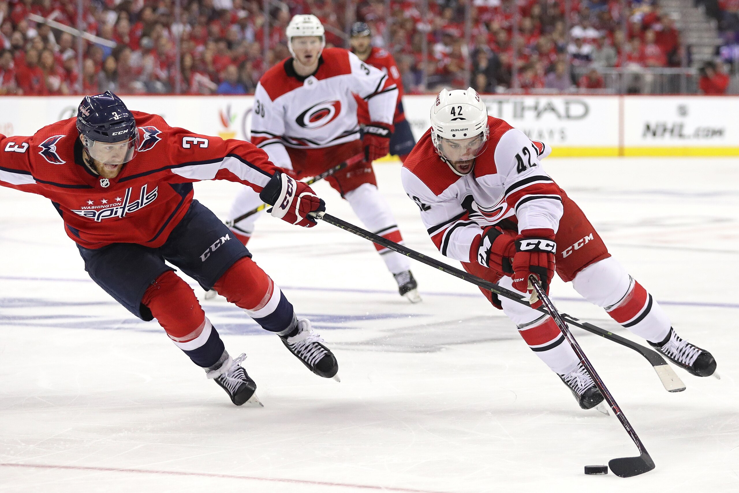 WASHINGTON, DC - APRIL 20: Greg McKegg #42 of the Carolina Hurricanes skates past Nick Jensen #3 of the Washington Capitals in the third period in Game Five of the Eastern Conference First Round during the 2019 NHL Stanley Cup Playoffs at Capital One Arena on April 20, 2019 in Washington, DC. (Photo by Patrick Smith/Getty Images)