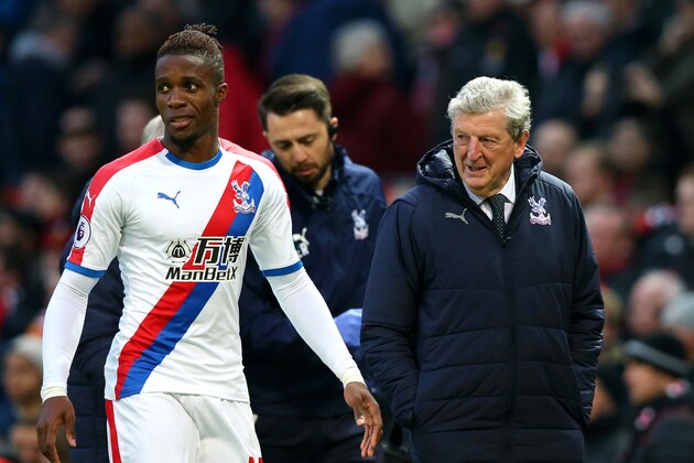 MANCHESTER, ENGLAND - NOVEMBER 24:  Wilfried Zaha of Crystal Palace speaks with Roy Hodgson, Manager of Crystal Palace following their sides draw in the Premier League match between Manchester United and Crystal Palace at Old Trafford on November 24, 2018 in Manchester, United Kingdom.  (Photo by Alex Livesey/Getty Images)