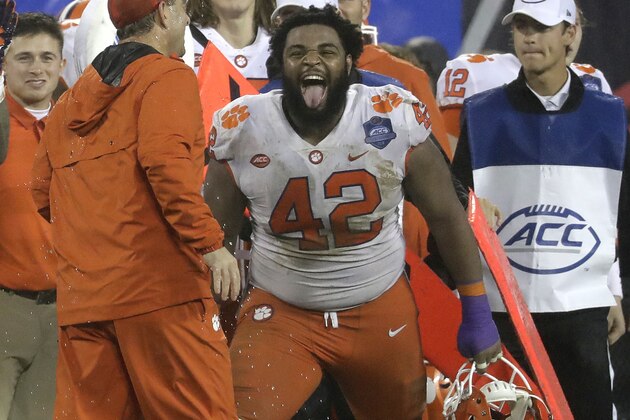 FILE - In this Saturday, Dec. 1, 2018, file photo, Clemson's Christian Wilkins (42) laughs with head coach Dabo Swinney in the closing seconds of the second half of the Atlantic Coast Conference championship NCAA college football game against Pittsburgh in Charlotte, N.C. Swinney keeps the mood light around his football program. He wants the Tigers to celebrate each victory and enjoy what it takes to get there. (AP Photo/Chuck Burton, File)