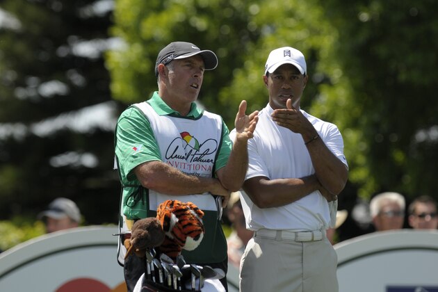 Caddie Steve Williams, left, and Tiger Woods discuss his shot during before teeing off on the second hole during the first round of the Arnold Palmer Invitational golf tournament at Bay Hill in Orlando, Fla., Thursday, March 24, 2011.(AP Photo/Phelan M. Ebenhack)