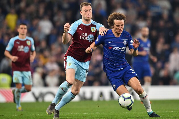 Burnley's English striker Ashley Barnes (CR) vies with Chelsea's Brazilian defender David Luiz (R) during the English Premier League football match between Chelsea and Burnley at Stamford Bridge in London on April 22, 2019. (Photo by Glyn KIRK / AFP) / RESTRICTED TO EDITORIAL USE. No use with unauthorized audio, video, data, fixture lists, club/league logos or 'live' services. Online in-match use limited to 120 images. An additional 40 images may be used in extra time. No video emulation. Social media in-match use limited to 120 images. An additional 40 images may be used in extra time. No use in betting publications, games or single club/league/player publications. /         (Photo credit should read GLYN KIRK/AFP/Getty Images)