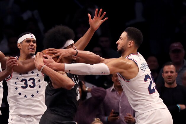 NEW YORK, NEW YORK - APRIL 20:  Jarrett Allen #31 of the Brooklyn Nets is surrounded by Tobias Harris #33 and Ben Simmons #25 of the Philadelphia 76ers in the final seconds of the game at Barclays Center on April 20, 2019 in the Brooklyn borough of New York City.The Philadelphia 76ers defeated the Brooklyn Nets 112-108. NOTE TO USER: User expressly acknowledges and agrees that, by downloading and or using this photograph, User is consenting to the terms and conditions of the Getty Images License Agreement. (Photo by Elsa/Getty Images)