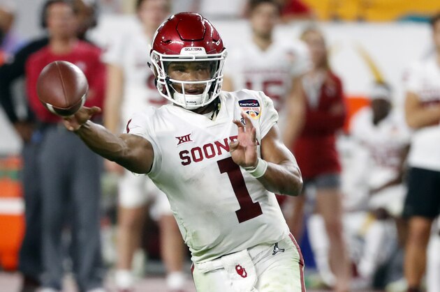 FILE - In this Dec. 29, 2018, file photo, Oklahoma quarterback Kyler Murray throws a pass during the second half of the Orange Bowl NCAA college football game against Alabama in Miami Gardens, Fla. The Oakland Athletics remain hopeful of seeing Heisman Trophy winner Murray in their baseball uniform when spring training begins next month. While the Oklahoma quarterback declared for the NFL draft last week, the prized outfielder could report to A’s spring training in Mesa, Arizona--and he has an invite to big league camp. (AP Photo/Wilfredo Lee, File)