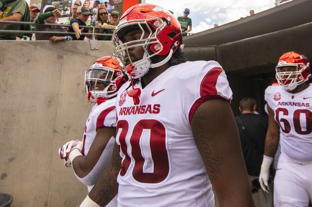 FORT COLLINS, CO - SEPTEMBER 08: Armon Watts #90 of the Arkansas Razorbacks, center, walks to the field with teammates before taking on the Colorado State Rams on September 8, 2018 in Fort Collins, Colorado. (Photo by Timothy Nwachukwu/Getty Images)
