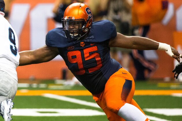 SYRACUSE, NY - SEPTEMBER 04:  Chris Slayton #95 of the Syracuse Orange pursues Paul Mroz #9 of the Rhode Island Rams during the first half on September 4, 2015 at The Carrier Dome in Syracuse, New York.  Syracuse Orange defeats Rhode Island Rams 47-0.  (Photo by Brett Carlsen/Getty Images)