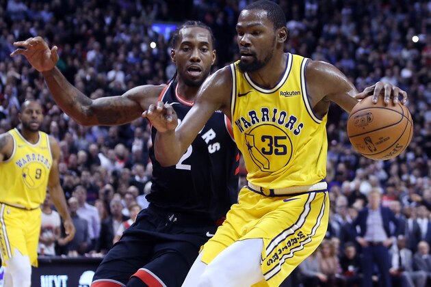 TORONTO, ON - NOVEMBER 29:  Kevin Durant #35 of the Golden State Warriors dribbles the ball as Kawhi Leonard #2 of the Toronto Raptors defends during the second half of an NBA game at Scotiabank Arena on November 29, 2018 in Toronto, Canada.  NOTE TO USER: User expressly acknowledges and agrees that, by downloading and or using this photograph, User is consenting to the terms and conditions of the Getty Images License Agreement.  (Photo by Vaughn Ridley/Getty Images)