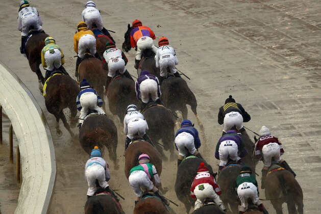 LOUISVILLE, KY - MAY 05:  The field of horses rounds the first turn during the 144th Kentucky Derby at Churchill Downs on May 5, 2018 in Louisville, Kentucky.  (Photo by Jamie Squire/Getty Images)