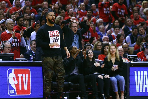 TORONTO, ON - APRIL 23:  Singer Drake (L) reacts from his courstside seat during Game Five of the first round of the 2019 NBA Playoffs between the Orlando Magic and the Toronto Raptors at Scotiabank Arena on April 23, 2019 in Toronto, Canada.  NOTE TO USER: User expressly acknowledges and agrees that, by downloading and or using this photograph, User is consenting to the terms and conditions of the Getty Images License Agreement.  (Photo by Vaughn Ridley/Getty Images)
