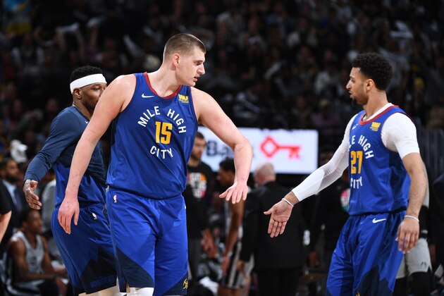 DENVER, CO - APRIL 23: Nikola Jokic #15 of the Denver Nuggets high-fives Jamal Murray #27 of the Denver Nuggets against the San Antonio Spurs during Game Five of Round One of the 2019 NBA Playoffson April 23, 2019 at the Pepsi Center in Denver, Colorado. NOTE TO USER: User expressly acknowledges and agrees that, by downloading and/or using this Photograph, user is consenting to the terms and conditions of the Getty Images License Agreement. Mandatory Copyright Notice: Copyright 2019 NBAE (Photo by Garrett Ellwood/NBAE via Getty Images)