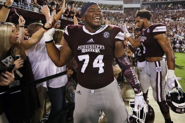Mississippi State offensive lineman Elgton Jenkins (74) is congratulated by fans following their NCAA college football game win against LSU in Starkville, Miss., Saturday, Sept. 16, 2017. Mississippi State won 37-7. (AP Photo/Rogelio V. Solis)