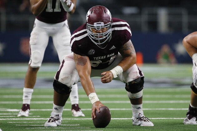 Texas A&M Aggies center Erik McCoy (center) waits to snap the ball to quarterback Kellen Mond (11) during the second half of an NCAA college football game against the Arkansas Razorbacks, Saturday, Sept. 29, 2018, in Arlington, Texas. (AP Photo/Roger Steinman)