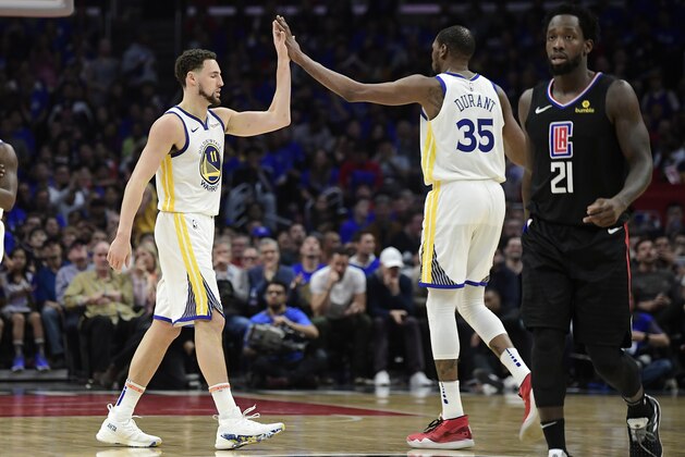 Golden State Warriors guard Klay Thompson, left, and forward Kevin Durant, center, congratulate each other as Los Angeles Clippers guard Patrick Beverley walks by during the second half in Game 4 of a first-round NBA basketball playoff series Sunday, April 21, 2019, in Los Angeles. The Warriors won 113-105. (AP Photo/Mark J. Terrill)