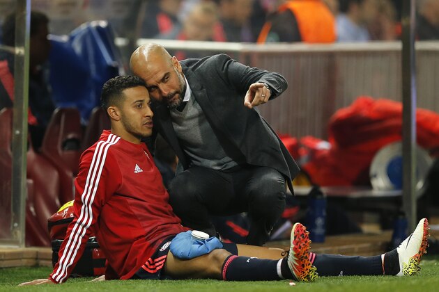 Bayern head coach Pep Guardiola, right, talks to Thiago during the Champions League 1st leg semifinal soccer match between Atletico Madrid and Bayern Munich at the Vicente Calderon stadium in Madrid, Spain, Wednesday, April 27, 2016. (AP Photo/Paul White)