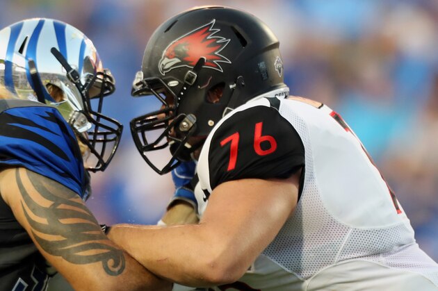 MEMPHIS, TN - SEPTEMBER 03: Jonathan Wilson #38 of the Memphis Tigers is blocked by Drew Forbes #76 of the Southeast Missouri Redhawks  on September 3, 2016 at Liberty Bowl Memorial Stadium in Memphis, Tennessee. Memphis defeated Southeast Missouri State 35-17. (Photo by Joe Murphy/Getty Images)