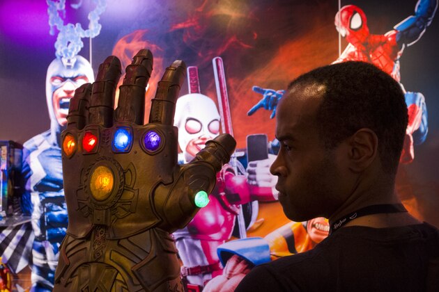 Rafael Jordan models the Infinity Gauntlet from Hasbro, Tuesday, Feb. 20, 2018, at the Toy Fair in New York. The 19.5-inch replica gauntlet will be worn by villain Thanos in