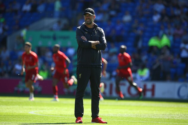 Liverpool's German manager Jurgen Klopp watches his players warm up for the English Premier League football match between between Cardiff City and Liverpool at Cardiff City Stadium in Cardiff, south Wales on April 21, 2019. (Photo by GEOFF CADDICK / AFP) / RESTRICTED TO EDITORIAL USE. No use with unauthorized audio, video, data, fixture lists, club/league logos or 'live' services. Online in-match use limited to 120 images. An additional 40 images may be used in extra time. No video emulation. Social media in-match use limited to 120 images. An additional 40 images may be used in extra time. No use in betting publications, games or single club/league/player publications. /         (Photo credit should read GEOFF CADDICK/AFP/Getty Images)