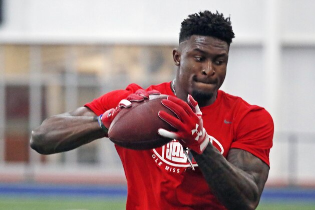 Former Mississippi football wide receiver DK Metcalf catches a pass while running pass patterns runs as he is tested by NFL scouts and coaches during Pro Day at Mississippi, Friday, March 29, 2019, in Oxford, Miss. (AP Photo/Rogelio V. Solis)