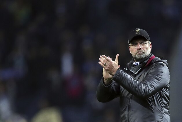 Liverpool manager Juergen Klopp, left, applauds to supporters at the end of the Champions League quarterfinals, 2nd leg, soccer match between FC Porto and Liverpool at the Dragao stadium in Porto, Portugal, Wednesday, April 17, 2019. (AP Photo/Luis Vieira)
