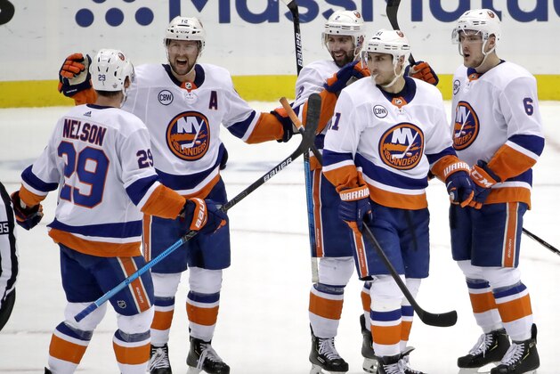 New York Islanders' Josh Bailey (12) celebrates his empty-net goal against the Pittsburgh Penguins during the third period in Game 4 of an NHL hockey first-round playoff series in Pittsburgh, Tuesday, April 16, 2019. The Islanders won 3-1, sweeping the series. (AP Photo/Gene J. Puskar)