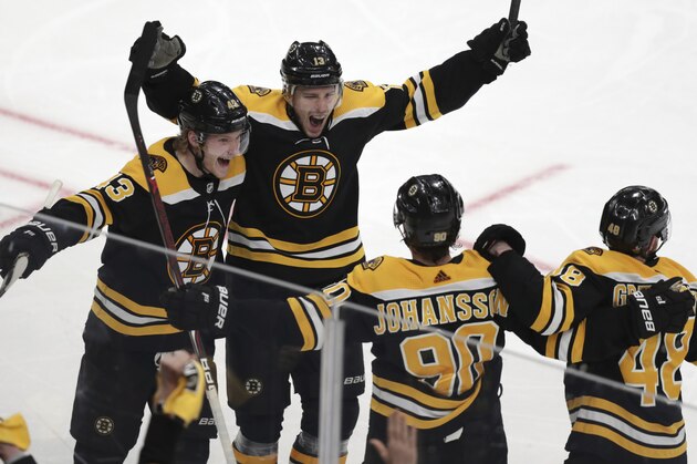 Boston Bruins center Charlie Coyle, center, celebrates with teammates after his game-winning goal off Columbus Blue Jackets goaltender Sergei Bobrovsky during overtime of Game 1 of an NHL hockey second-round playoff series, Thursday, April 25, 2019, in Boston. The Bruins won 3-2. (AP Photo/Charles Krupa)