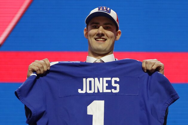 Duke quarterback Daniel Jones poses with his new jersey after the New York Giants selected Jones in the first round at the NFL football draft, Thursday, April 25, 2019, in Nashville, Tenn. (AP Photo/Mark Humphrey)