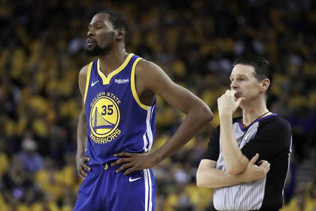 Golden State Warriors' Kevin Durant, left, waits for play to resume in the second half in Game 5 of a first-round NBA basketball playoff series against the Los Angeles Clippers, Wednesday, April 24, 2019, in Oakland, Calif. (AP Photo/Ben Margot)