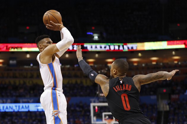 Oklahoma City Thunder guard Russell Westbrook (0) shoots as Portland Trail Blazers guard Damian Lillard (0) defends in the first half of Game 4 of an NBA basketball first-round playoff series Sunday, April 21, 2019, in Oklahoma City. (AP Photo/Alonzo Adams)