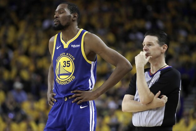Golden State Warriors' Kevin Durant, left, waits for play to resume in the second half in Game 5 of a first-round NBA basketball playoff series against the Los Angeles Clippers, Wednesday, April 24, 2019, in Oakland, Calif. (AP Photo/Ben Margot)