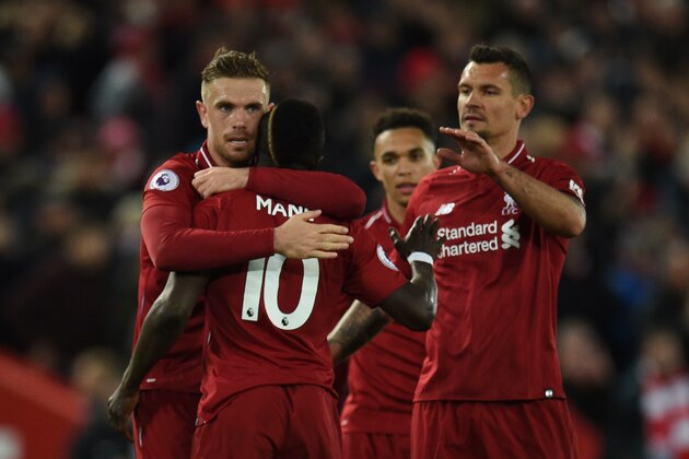 Liverpool's Senegalese striker Sadio Mane (2L) celebrates with teammates after he scores the team's fourth goal during the English Premier League football match between Liverpool and Huddersfield at Anfield in Liverpool, north west England on April 26, 2019. (Photo by Oli SCARFF / AFP) / RESTRICTED TO EDITORIAL USE. No use with unauthorized audio, video, data, fixture lists, club/league logos or 'live' services. Online in-match use limited to 120 images. An additional 40 images may be used in extra time. No video emulation. Social media in-match use limited to 120 images. An additional 40 images may be used in extra time. No use in betting publications, games or single club/league/player publications. /         (Photo credit should read OLI SCARFF/AFP/Getty Images)
