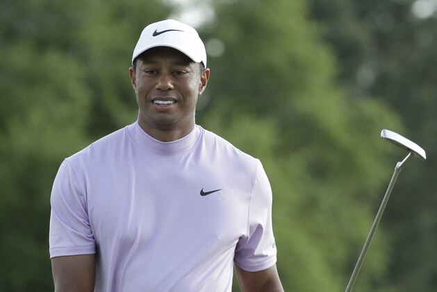 Tiger Woods smiles as he walks off the 18th green during the third round for the Masters golf tournament Saturday, April 13, 2019, in Augusta, Ga. (AP Photo/Chris Carlson)