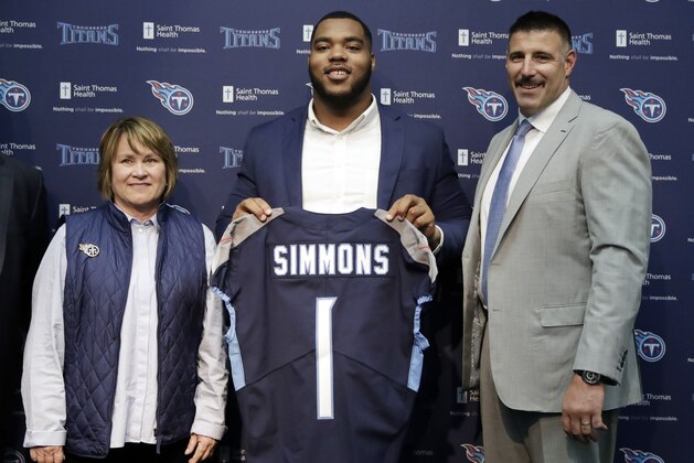 Mississippi State defensive tackle Jeffery Simmons, center, poses with Tennessee Titans owner Amy Adams Strunk, left, and head coach Mike Vrabel, right, during an NFL football news conference Friday, April 26, 2019, in Nashville, Tenn. Simmons was selected in the first round by the Titans. (AP Photo/Mark Humphrey)