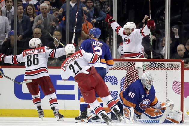 Carolina Hurricanes center Jordan Staal, top right, reacts after scoring an overtime goal on New York Islanders goaltender Robin Lehner (40), of Sweden, during Game 1 of an NHL hockey second-round playoff series, Friday, April 26, 2019, in New York. The Hurricanes won 1-0. (AP Photo/Julio Cortez)