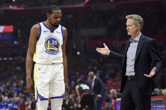Golden State Warriors coach Steve Kerr, right, talks to forward Kevin Durant during the first half in Game 3 of the team's first-round NBA basketball playoff series against the Los Angeles Clippers on Thursday, April 18, 2019, in Los Angeles. (AP Photo/Mark J. Terrill)
