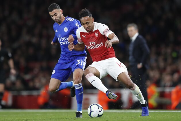 Arsenal's Pierre-Emerick Aubameyang, right, vies for the ball with Leicester City's Rachid Ghezzal during the English Premier League soccer match between Arsenal and Leicester City at the Emirates stadium in London, Monday, Oct. 22, 2018. (AP Photo/Alastair Grant)