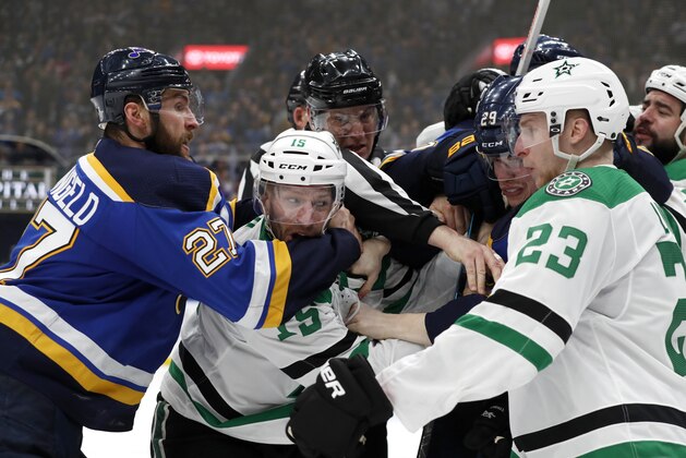 St. Louis Blues' Alex Pietrangelo (27) and Dallas Stars' Esa Lindell (23) help to break up a fight between the Stars' Blake Comeau (15) and the Blues' Vince Dunn (29) during the third period in Game 1 of an NHL second-round hockey playoff series Thursday, April 25, 2019, in St. Louis. (AP Photo/Jeff Roberson)