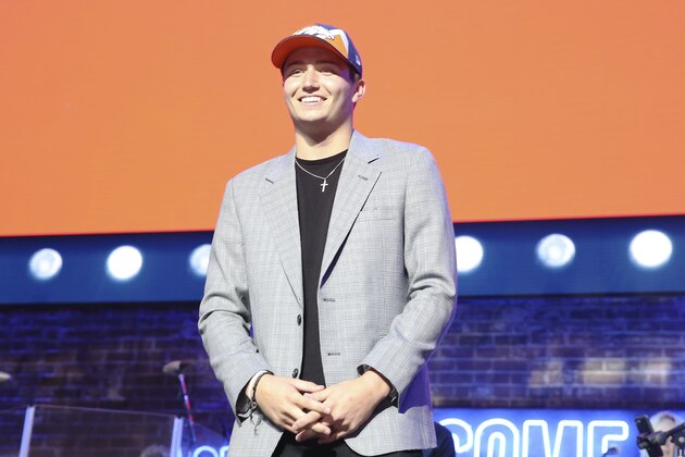 Missouri quarterback Drew Lock poses on stage after the Denver Broncos selected Lock during the second round of the NFL football draft, Friday, April 26, 2019, in Nashville, Tenn. (AP Photo/Steve Luciano)
