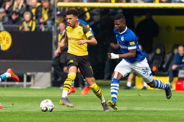 DORTMUND, GERMANY - APRIL 27: Jadon Sancho of Borussia Dortmund and Breel Embolo of FC Schalke 04 battle for the ball during the Bundesliga match between Borussia Dortmund and FC Schalke 04 at Signal Iduna Park on April 27, 2019 in Dortmund, Germany. (Photo by TF-Images/Getty Images)
