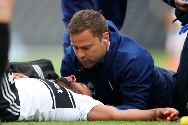 LONDON, ENGLAND - APRIL 27:  Denis Odoi of Fulham receives medical treatment during the Premier League match between Fulham FC and Cardiff City at Craven Cottage on April 27, 2019 in London, United Kingdom. (Photo by Catherine Ivill/Getty Images)