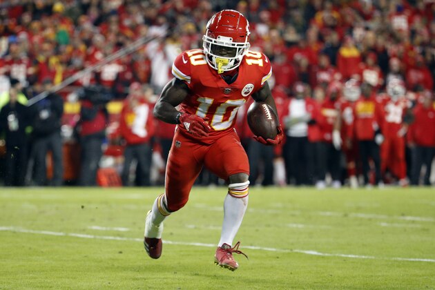 Kansas City Chiefs wide receiver Tyreek Hill (10) runs with the ball during the first half of an NFL football game against the Los Angeles Chargers in Kansas City, Mo., Thursday, Dec. 13, 2018. (AP Photo/Charlie Riedel)