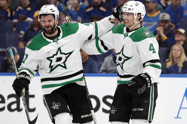 Dallas Stars' Miro Heiskanen (4), of Finland, is congratulated by Alexander Radulov after scoring during the first period in Game 2 of an NHL second-round hockey playoff series against the St. Louis Blues Saturday, April 27, 2019, in St. Louis. (AP Photo/Jeff Roberson)