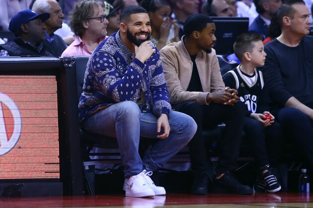 TORONTO, ON - APRIL 27:  Singer Drake smiles from his court side seat during Game One of the second round of the 2019 NBA Playoffs between the Philadelphia 76ers and the Toronto Raptors at Scotiabank Arena on April 27, 2019 in Toronto, Canada.  NOTE TO USER: User expressly acknowledges and agrees that, by downloading and or using this photograph, User is consenting to the terms and conditions of the Getty Images License Agreement.  (Photo by Vaughn Ridley/Getty Images)