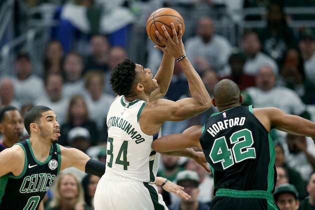 MILWAUKEE, WISCONSIN - APRIL 28:  Giannis Antetokounmpo #34 of the Milwaukee Bucks attempts a shot while being guarded by Jayson Tatum #0 and Al Horford #42 of the Boston Celtics in the first quarter during Game One of Round Two of the 2019 NBA Playoffs at the Fiserv Forum on April 28, 2019 in Milwaukee, Wisconsin. NOTE TO USER: User expressly acknowledges and agrees that, by downloading and or using this photograph, User is consenting to the terms and conditions of the Getty Images License Agreement. (Photo by Dylan Buell/Getty Images)