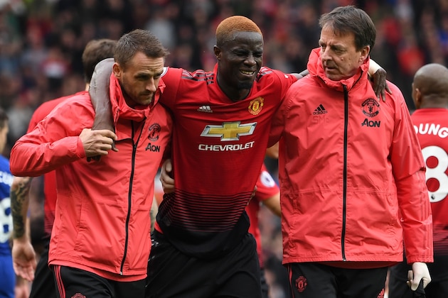 Manchester United's Ivorian defender Eric Bailly (C) goes off with an injury during the English Premier League football match between Manchester United and Chelsea at Old Trafford in Manchester, north west England, on April 28, 2019. (Photo by Paul ELLIS / AFP) / RESTRICTED TO EDITORIAL USE. No use with unauthorized audio, video, data, fixture lists, club/league logos or 'live' services. Online in-match use limited to 120 images. An additional 40 images may be used in extra time. No video emulation. Social media in-match use limited to 120 images. An additional 40 images may be used in extra time. No use in betting publications, games or single club/league/player publications. /         (Photo credit should read PAUL ELLIS/AFP/Getty Images)