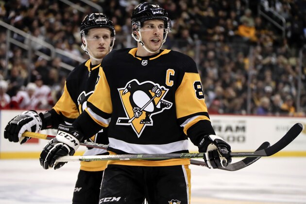 Pittsburgh Penguins' Sidney Crosby (87) and Jake Guentzel prepare for a face-off during an NHL hockey game against the Detroit Red Wings in Pittsburgh, Thursday, April 4, 2019. (AP Photo/Gene J. Puskar)