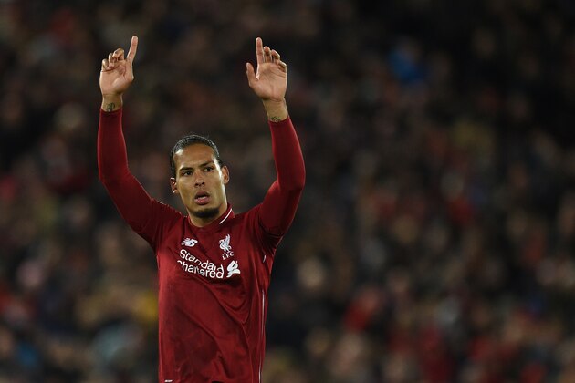 Liverpool's Dutch defender Virgil van Dijk acknowledges supporters  during the English Premier League football match between Liverpool and Huddersfield at Anfield in Liverpool, north west England on April 26, 2019. (Photo by Oli SCARFF / AFP) / RESTRICTED TO EDITORIAL USE. No use with unauthorized audio, video, data, fixture lists, club/league logos or 'live' services. Online in-match use limited to 120 images. An additional 40 images may be used in extra time. No video emulation. Social media in-match use limited to 120 images. An additional 40 images may be used in extra time. No use in betting publications, games or single club/league/player publications. /         (Photo credit should read OLI SCARFF/AFP/Getty Images)