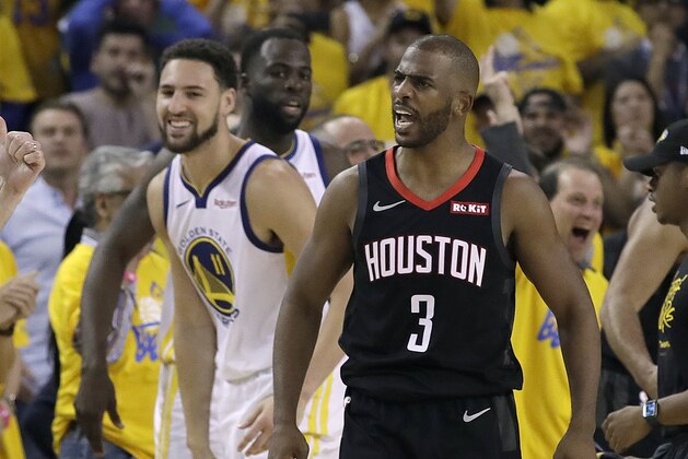 Golden State Warriors guard Klay Thompson, left, smiles as Houston Rockets guard Chris Paul (3) is ejected during the second half of Game 1 of a second-round NBA basketball playoff series in Oakland, Calif., Sunday, April 28, 2019. (AP Photo/Jeff Chiu)