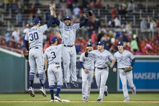WASHINGTON, DC - APRIL 26: Eric Hosmer #30 and Manuel Margot #7 of the San Diego Padres celebrate after beating the against the Washington Nationals at Nationals Park on April 26, 2019 in Washington, DC. (Photo by Scott Taetsch/Getty Images)