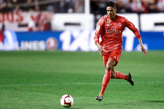 Real Madrid's French defender Raphael Varane runs with the ball during the Spanish League football match between Rayo Vallecano and Real Madrid at the Vallecas Stadium in the Madrid district of Puente de Vallecas on April 28, 2019. (Photo by BENJAMIN CREMEL / AFP)        (Photo credit should read BENJAMIN CREMEL/AFP/Getty Images)