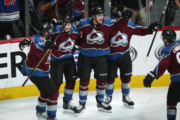 Colorado Avalanche right wing Mikko Rantanen, third from left, celebrates his overtime goal with, from left, defensemen Patrik Nemeth, Cale Makar and Tyson Barrie in Game 4 of the team's NHL hockey playoff series against Calgary Flames on Wednesday, April 17, 2019, in Denver. The Avalanche won 3-2. (AP Photo/David Zalubowski)